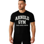 Athletic male model in a black Arnold Gym T-shirt for bodybuilding, featuring the slogan Train. Build. Repeat. on chest