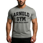 Man posing in a heather grey Arnold Gym workout T-shirt with bold Train. Build. Repeat. slogan, designed for bodybuilding.-