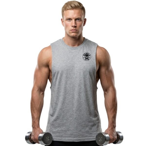 Fit male model holding dumbbells wearing a Grey Sleeveless Gym Top for Mens with raw edge slash armholes and black Arnold Gym logo. Bodybuilding muscle tank style.